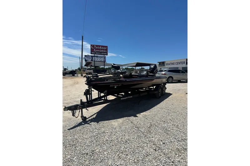 The Image of 1993 SeaRanger 492V boat on trailer at outdoor dealership under clear blue sky. - 1
