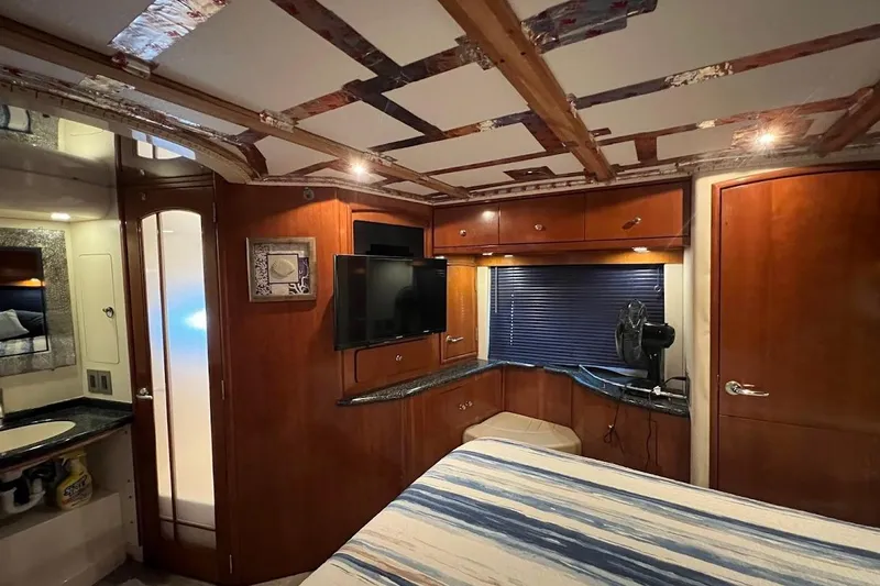 Slide: The Image of Interior of 2000 Carver 506 Motor Yacht with wood cabinetry and modern amenities. - 12