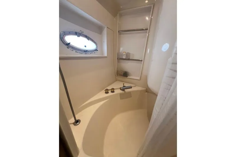 Slide: The Image of Bathroom interior of 2000 Carver 506 Motor Yacht with porthole and shower. - 16