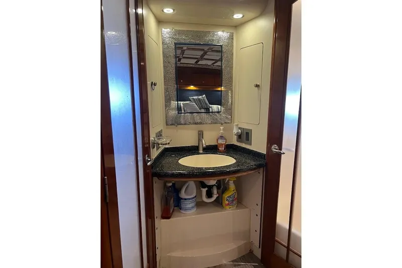 Slide: The Image of Bathroom vanity in 2000 Carver 506 Motor Yacht with mirror and storage. - 17