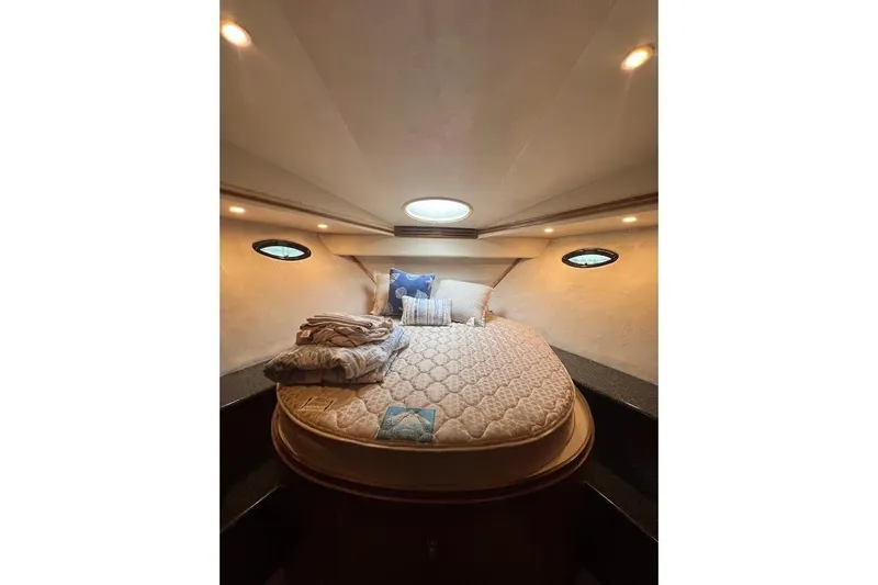 Slide: The Image of Luxurious bedroom interior of 2000 Carver 506 Motor Yacht with cozy bedding and ambient lighting. - 20