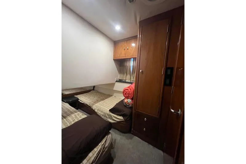 Slide: The Image of Interior cabin of 2000 Carver 506 Motor Yacht with twin beds and wooden cabinetry. - 21