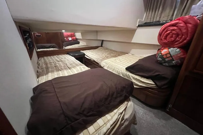 Slide: The Image of Cozy twin cabin in 2000 Carver 506 Motor Yacht with bedding and storage. - 22