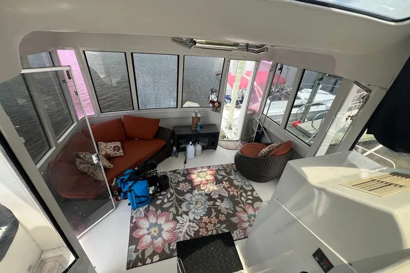 Slide: The Image of Interior of 2000 Carver 506 Motor Yacht with cozy seating and floral rug. - 25