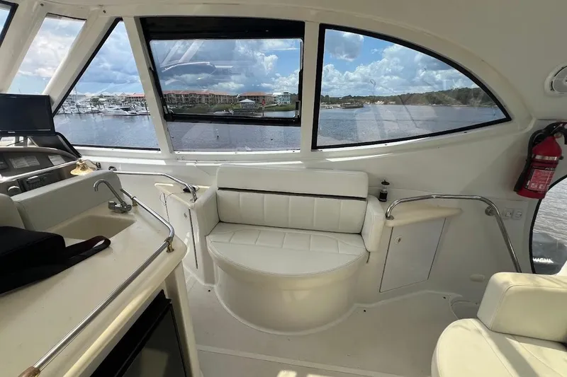 Slide: The Image of Interior of 2000 Carver 506 Motor Yacht with seating and marina view. - 27