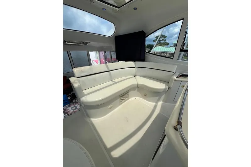 Slide: The Image of Interior of 2000 Carver 506 Motor Yacht with white seating and large windows. - 28