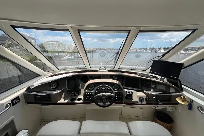 Slide: The Image of Cockpit view of 2000 Carver 506 Motor Yacht with marina in background. - 30