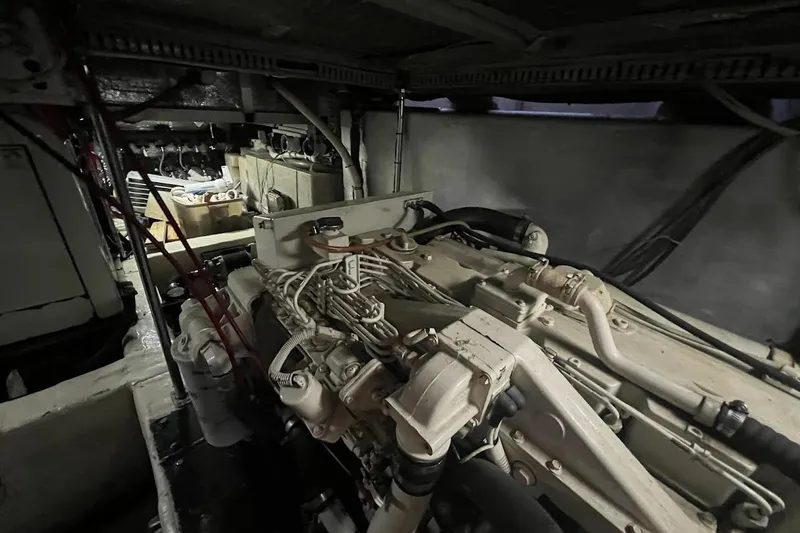 Slide: The Image of Engine room of a 2000 Carver 506 Motor Yacht, showcasing mechanical components and wiring. - 33