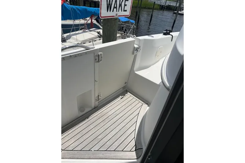 Slide: The Image of 2000 Carver 506 Motor Yacht deck with "No Wake" sign in marina setting. - 36