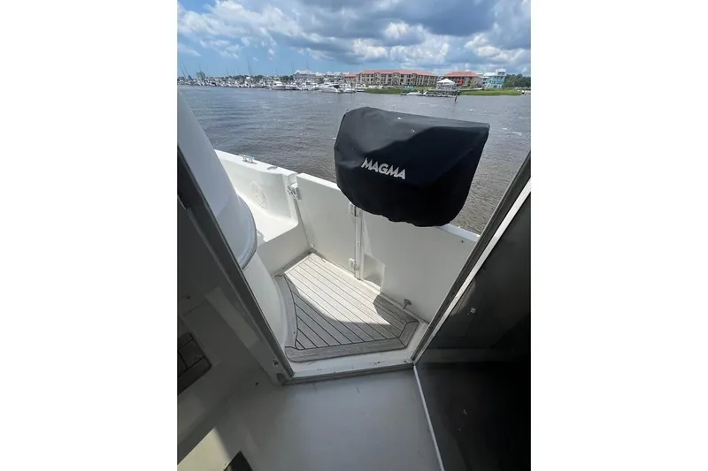 Slide: The Image of Carver 506 Motor Yacht 2000 deck view with covered grill, overlooking marina. - 37