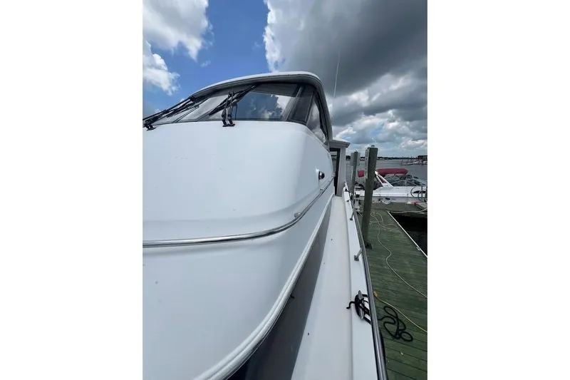 Slide: The Image of 2000 Carver 506 Motor Yacht docked under cloudy skies. - 38