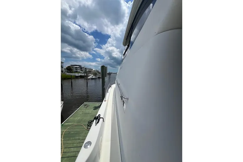 Slide: The Image of Side view of a 2000 Carver 506 Motor Yacht docked under cloudy skies. - 39