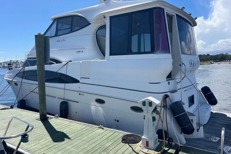 Slide: The Image of 2000 Carver 506 Motor Yacht docked at marina under clear blue sky. - 40