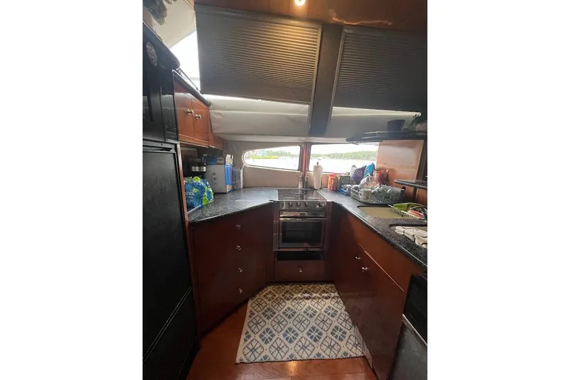 Slide: The Image of Interior kitchen of 2000 Carver 506 Motor Yacht with modern appliances and countertop. - 5
