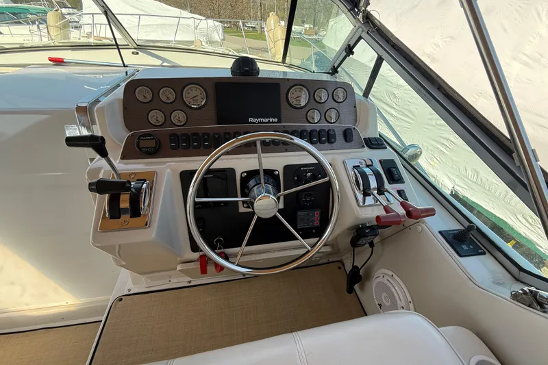 Slide: The Image of 1992 Wellcraft 3400 Gran Sport helm with steering wheel and control panel. - 10