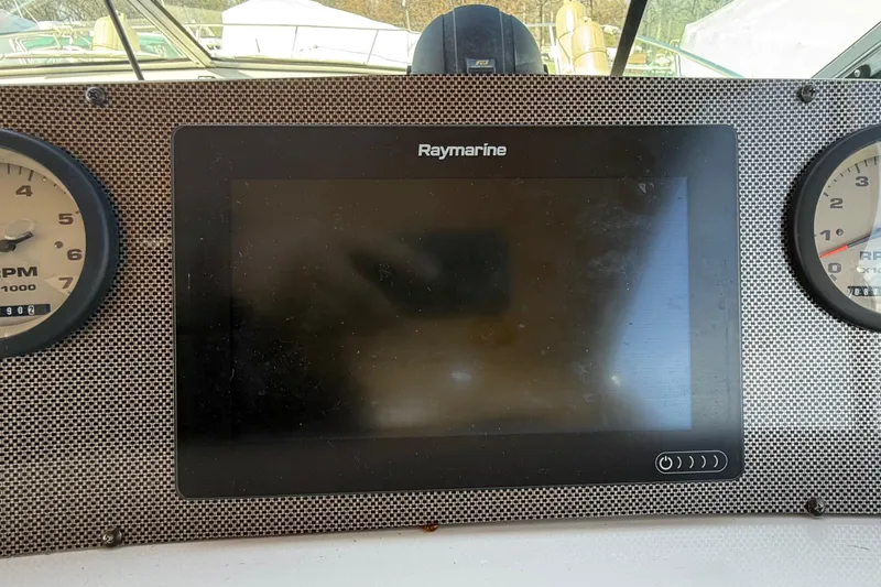 Slide: The Image of Dashboard of a 1992 Wellcraft 3400 Gran Sport with Raymarine display and RPM gauges. - 12