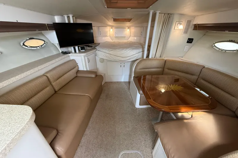 Slide: The Image of Interior of 1992 Wellcraft 3400 Gran Sport yacht with cozy seating and dining area. - 13