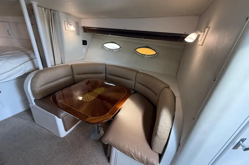 Slide: The Image of Interior of 1992 Wellcraft 3400 Gran Sport with cozy dining area and pineapple table design. - 14