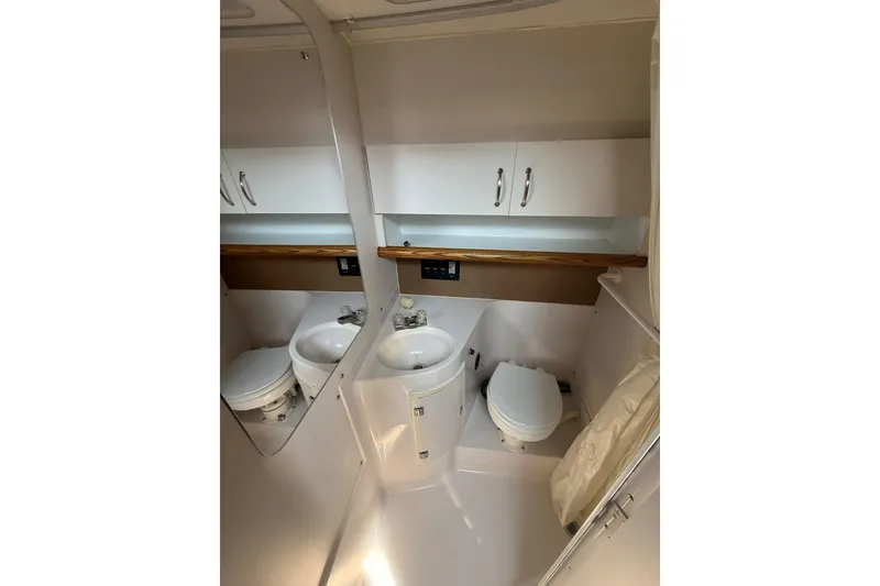 Slide: The Image of Bathroom interior of 1992 Wellcraft 3400 Gran Sport boat, featuring sink and toilet. - 19