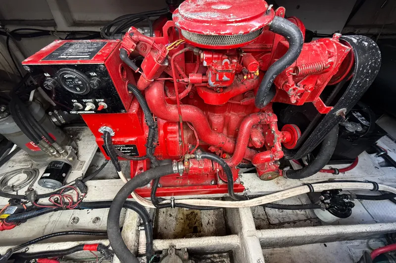 Slide: The Image of Engine compartment of a 1992 Wellcraft 3400 Gran Sport boat, featuring a red engine. - 23