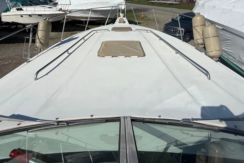 Slide: The Image of 1992 Wellcraft 3400 Gran Sport boat deck with railings and hatch, docked outdoors. - 5