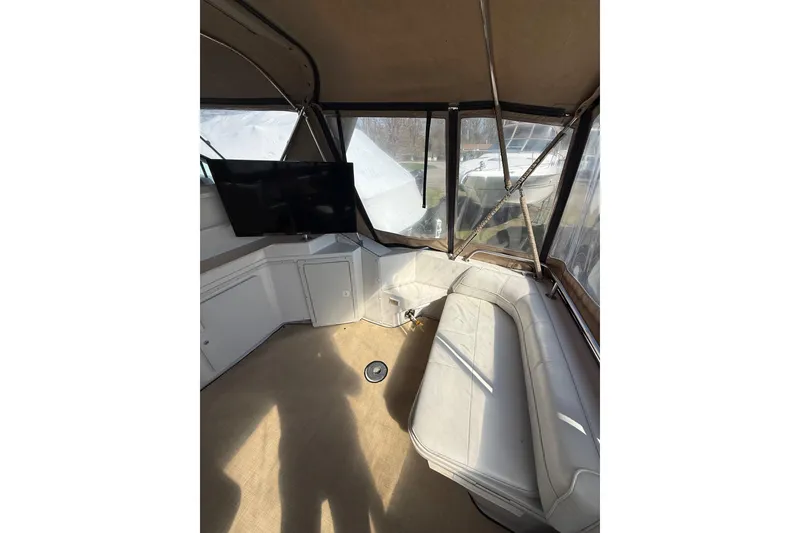Slide: The Image of Interior of 1992 Wellcraft 3400 Gran Sport boat with seating and mounted TV. - 6