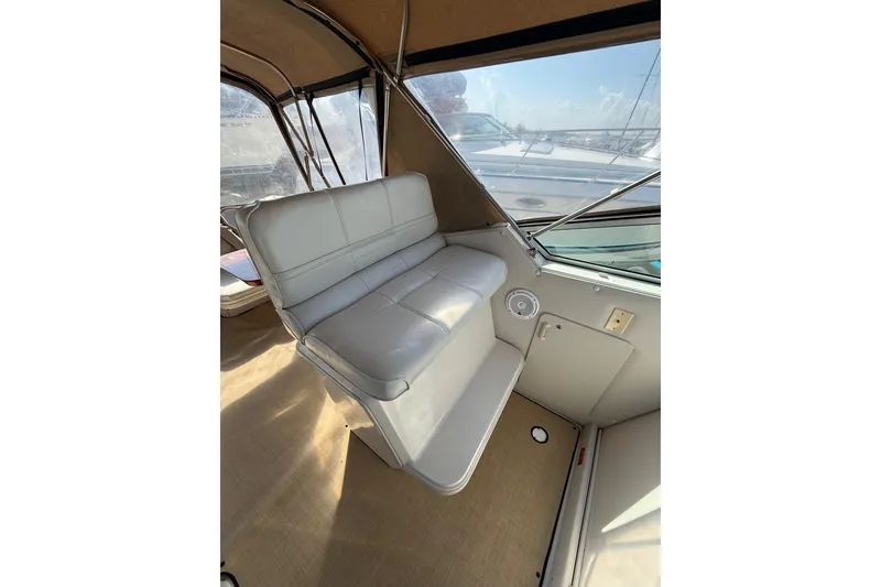 Slide: The Image of Interior seating of 1992 Wellcraft 3400 Gran Sport boat, featuring white leather upholstery. - 8