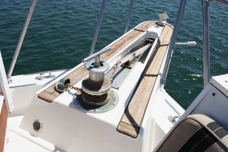 Slide: The Image of 1979 Hatteras 58 Motor Yacht anchor winch on deck, surrounded by ocean water. - 11