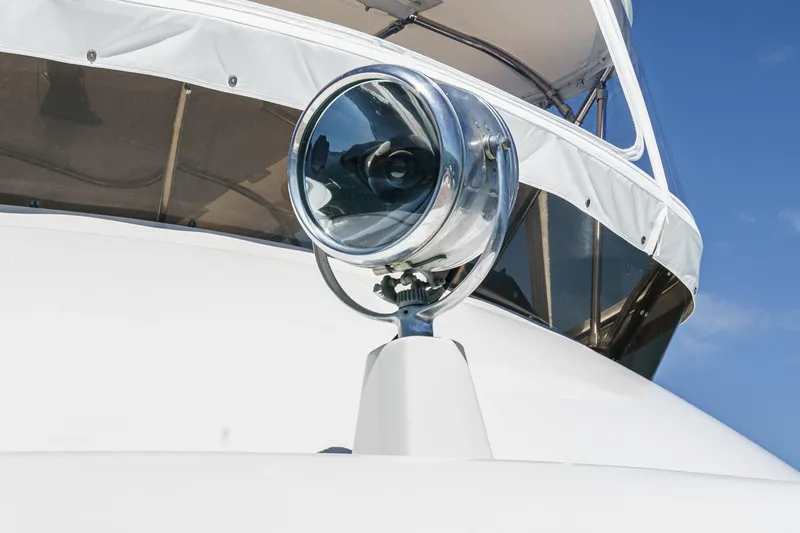 Slide: The Image of 1979 Hatteras 58 Motor Yacht spotlight against clear blue sky. - 12