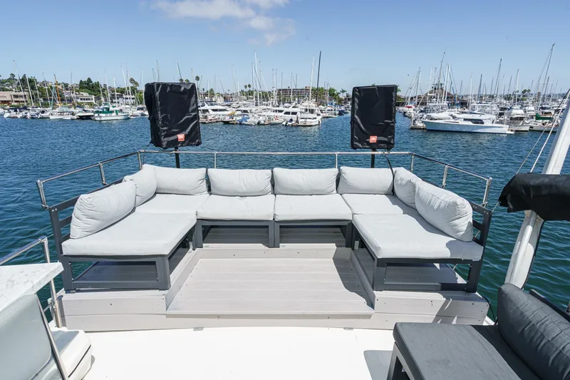 Slide: The Image of 1979 Hatteras 58 Motor Yacht deck with cushioned seating, overlooking marina. - 18