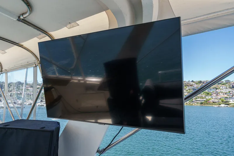 Slide: The Image of Flat-screen TV on 1979 Hatteras 58 Motor Yacht, overlooking marina and waterfront homes. - 23