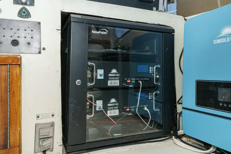 Slide: The Image of Electrical equipment setup on a 1979 Hatteras 58 Motor Yacht, featuring Sungoldpower components. - 25