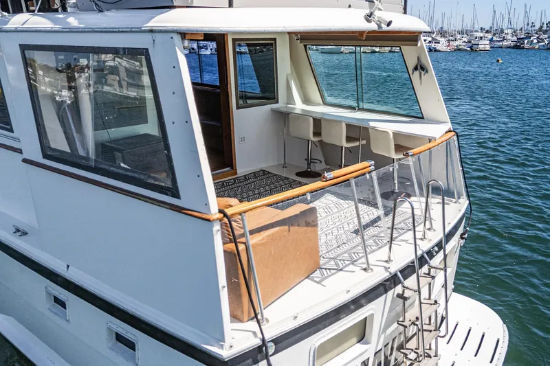 Slide: The Image of 1979 Hatteras 58 Motor Yacht with spacious deck and marina view. - 31