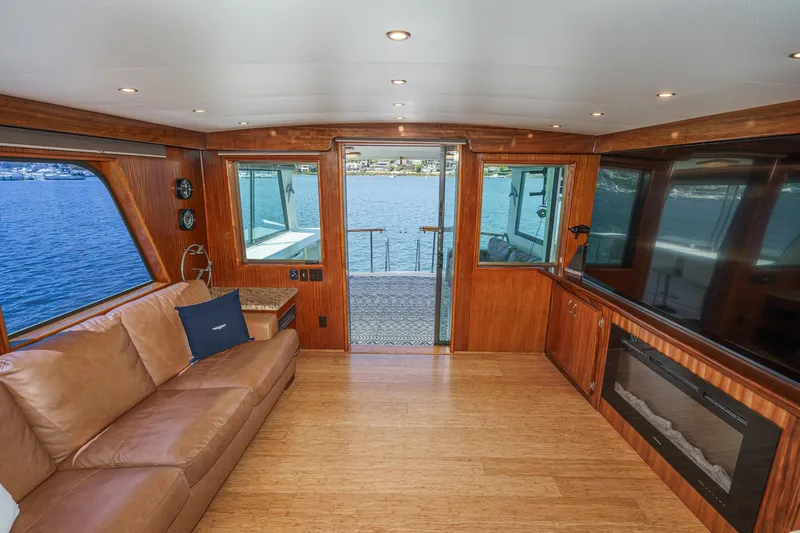 Slide: The Image of Luxurious interior of 1979 Hatteras 58 Motor Yacht with leather seating and waterfront view. - 34