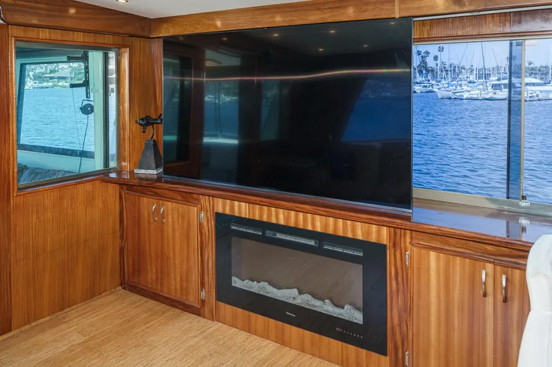Slide: The Image of Interior of 1979 Hatteras 58 Motor Yacht with TV and fireplace, overlooking marina. - 36