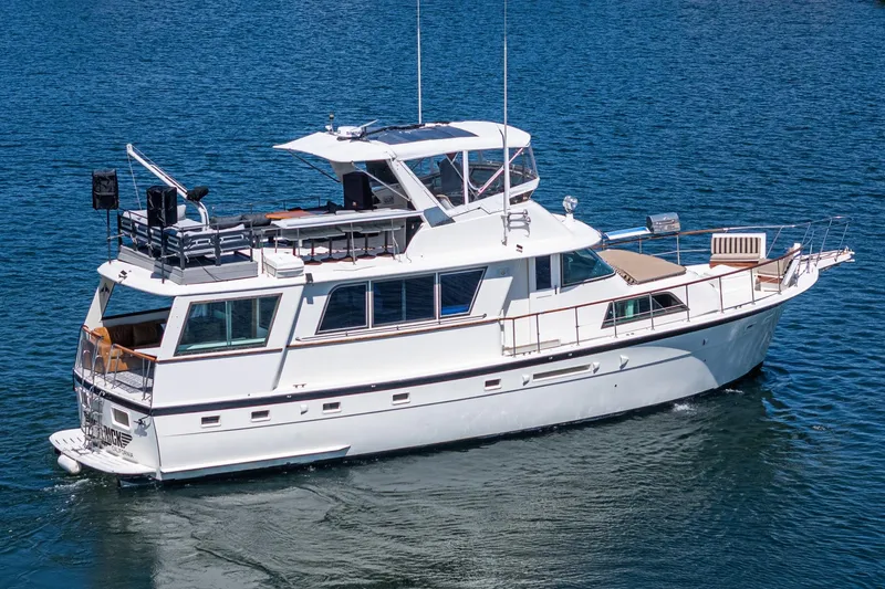 Slide: The Image of 1979 Hatteras 58 Motor Yacht cruising on blue water, showcasing classic design and elegance. - 4