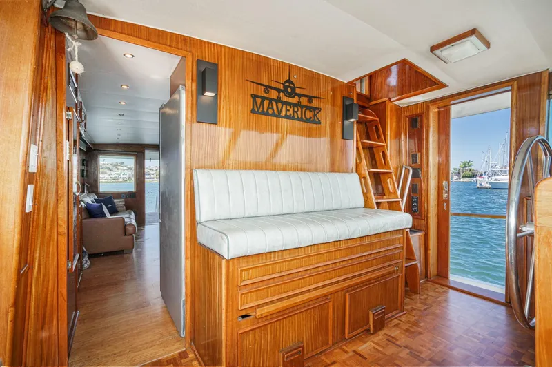 Slide: The Image of 1979 Hatteras 58 Motor Yacht interior with wood paneling and waterfront view. - 40