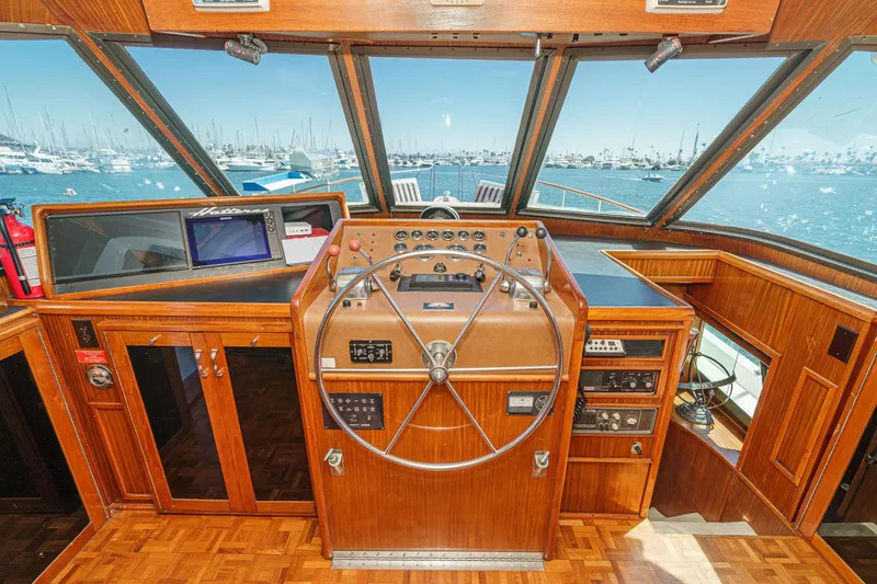 Slide: The Image of 1979 Hatteras 58 Motor Yacht helm with wooden interior and ocean view. - 43