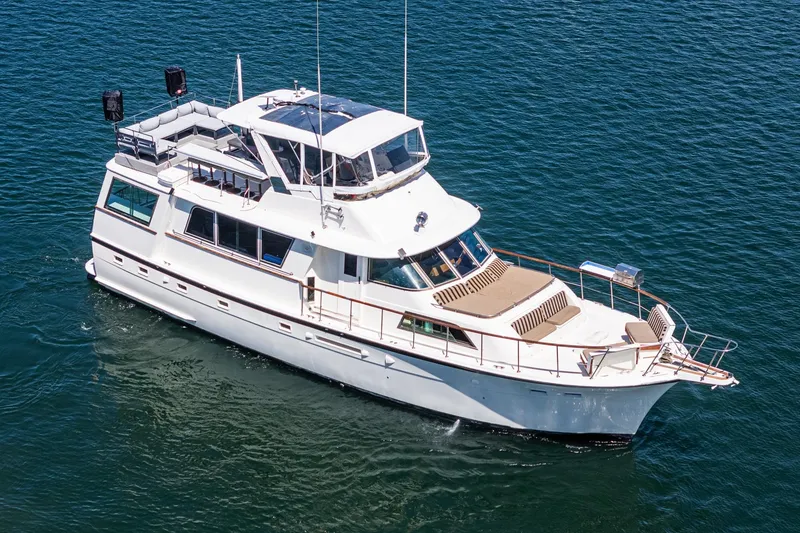 Slide: The Image of 1979 Hatteras 58 Motor Yacht cruising on open water, aerial view. - 5