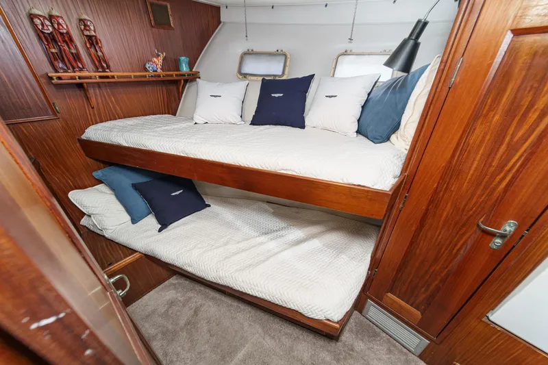 Slide: The Image of 1979 Hatteras 58 Motor Yacht cabin with wooden bunk beds and nautical decor. - 51
