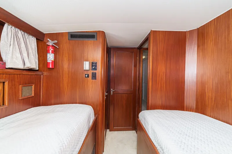 Slide: The Image of Interior cabin of 1979 Hatteras 58 Motor Yacht with twin beds and wood paneling. - 54