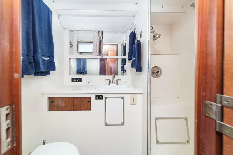 Slide: The Image of 1979 Hatteras 58 Motor Yacht bathroom with sink, mirror, and shower. - 55
