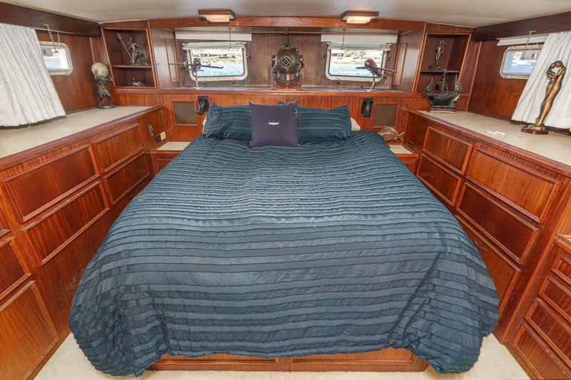 Slide: The Image of Luxurious bedroom interior of 1979 Hatteras 58 Motor Yacht with elegant wood cabinetry. - 56