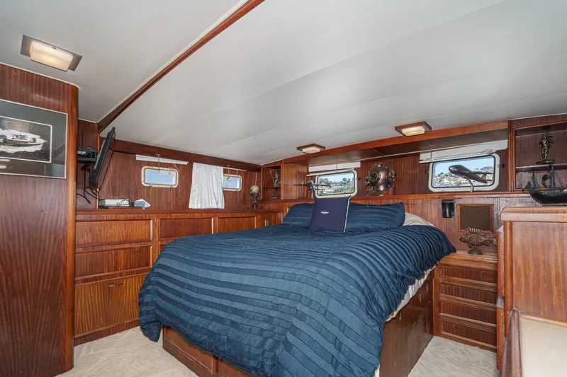 Slide: The Image of Interior of 1979 Hatteras 58 Motor Yacht with cozy bedroom and nautical decor. - 57