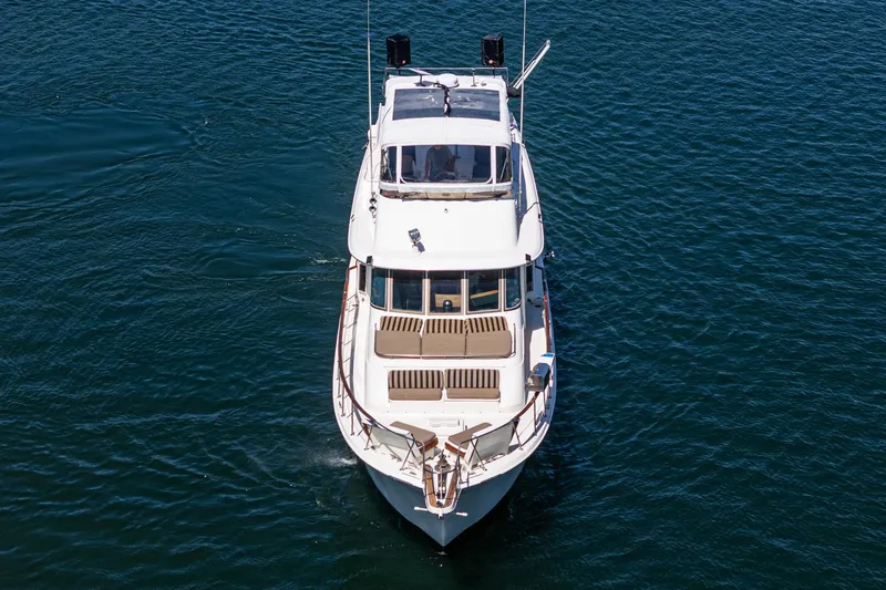 Slide: The Image of 1979 Hatteras 58 Motor Yacht cruising on open water, aerial view. - 6