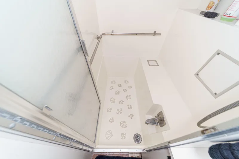 Slide: The Image of Shower area in 1979 Hatteras 58 Motor Yacht with sliding glass door and handrail. - 62