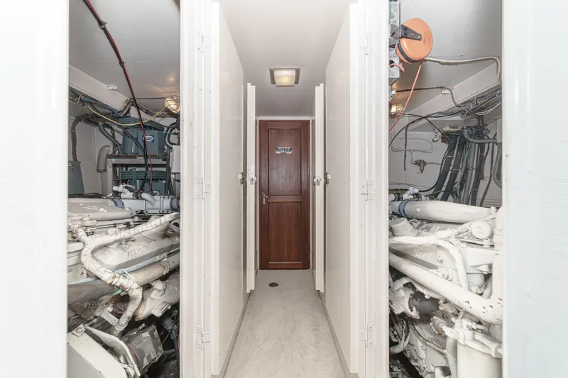 Slide: The Image of Engine room of 1979 Hatteras 58 Motor Yacht with visible machinery and wiring. - 64