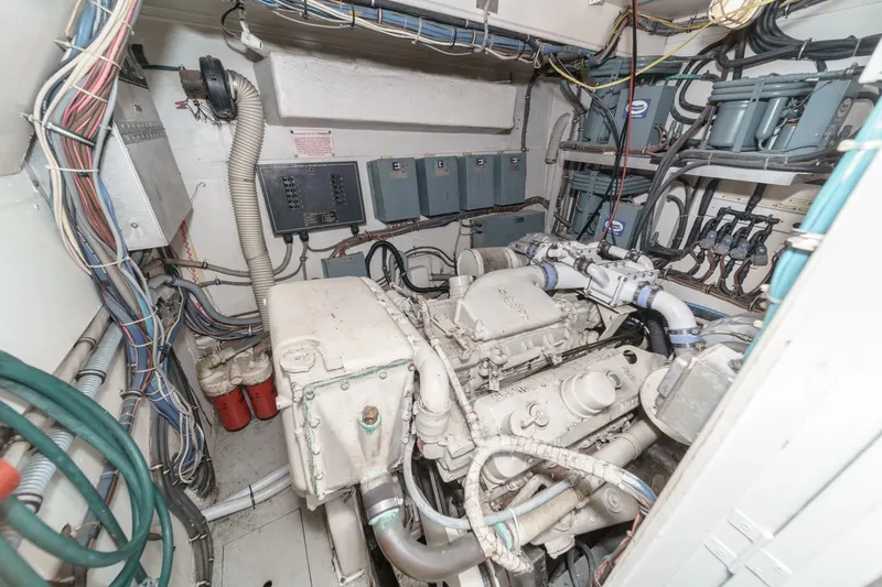 Slide: The Image of Engine room of a 1979 Hatteras 58 Motor Yacht with visible wiring and machinery. - 65