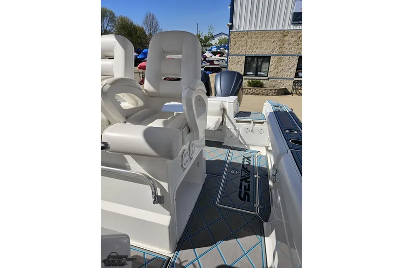 Slide: The Image of 2013 Sea Fox 286 Commander boat interior with cushioned seating and sleek design. - 100