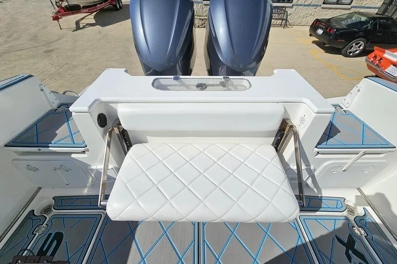 Slide: The Image of 2013 Sea Fox 286 Commander boat interior with white quilted seating and dual outboard motors. - 111